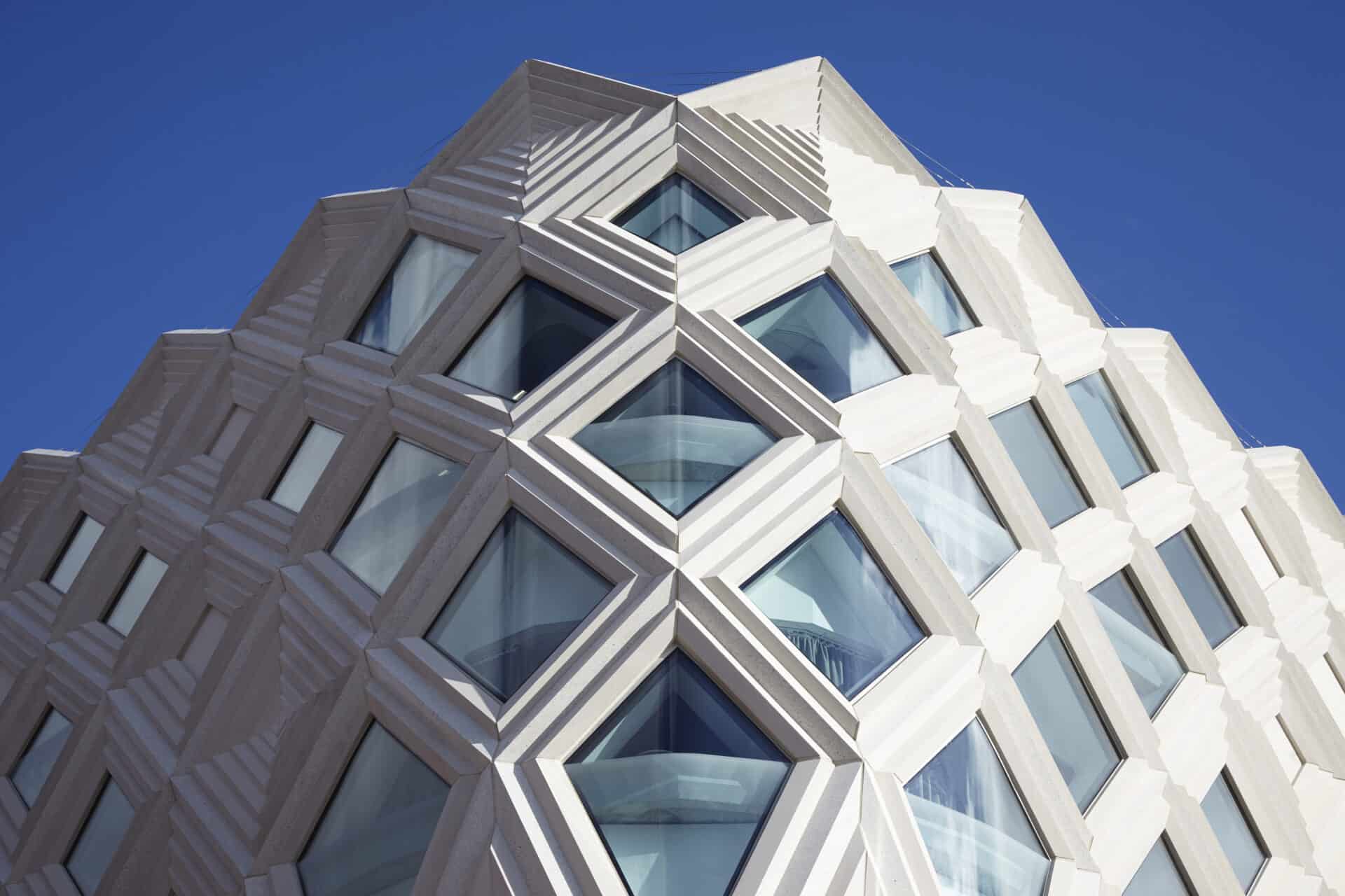 Modern architectural building at Victoria Leeds with geometric design and glass windows.